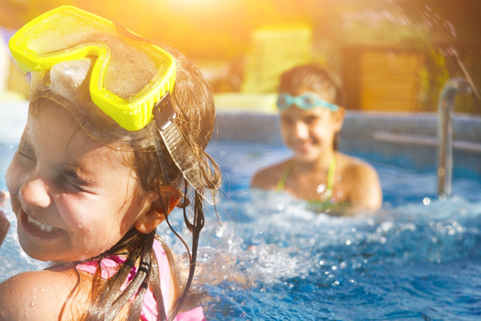Two kids swimming in pool at Southwest Florida vacation rental