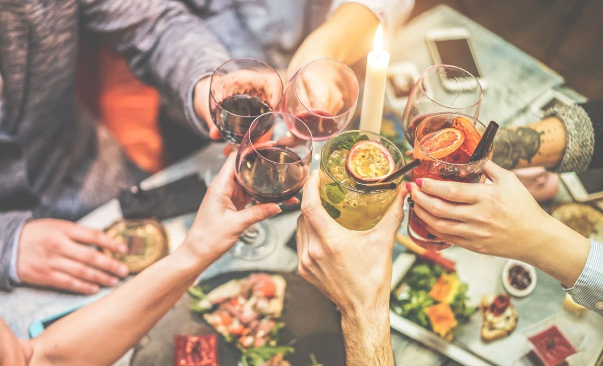 Friends clinking drinks together