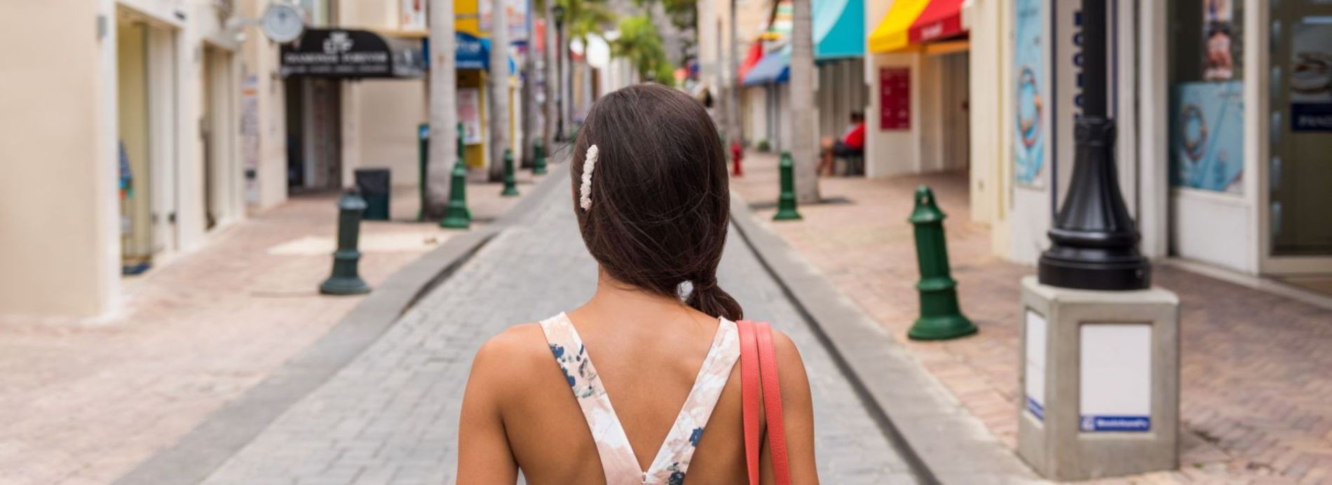 woman walking down ally with back to camera