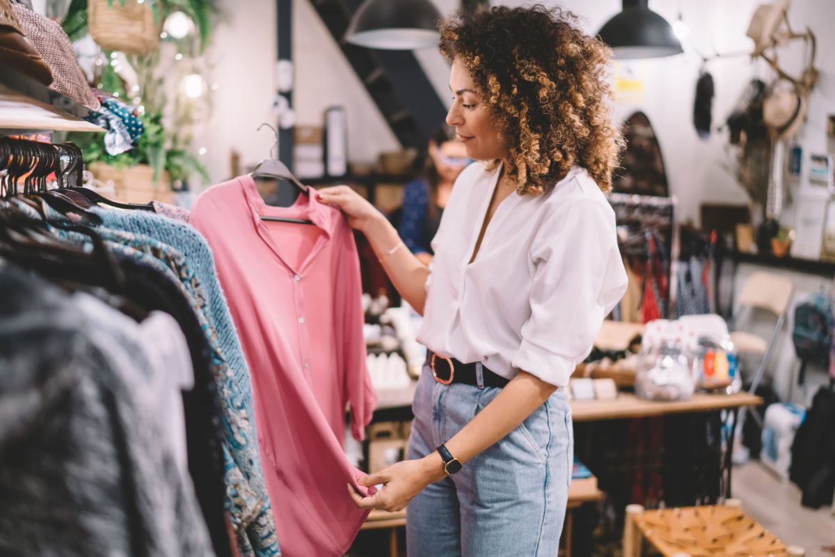 Woman browsing for clothing in boutique