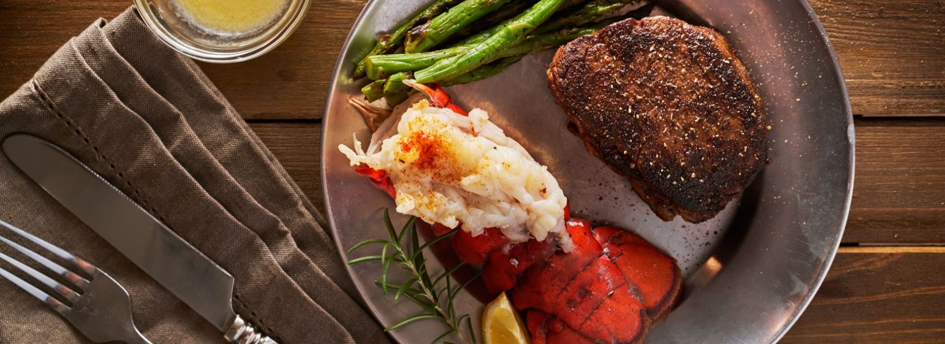 Steak and lobster dinner with asparagus and butter